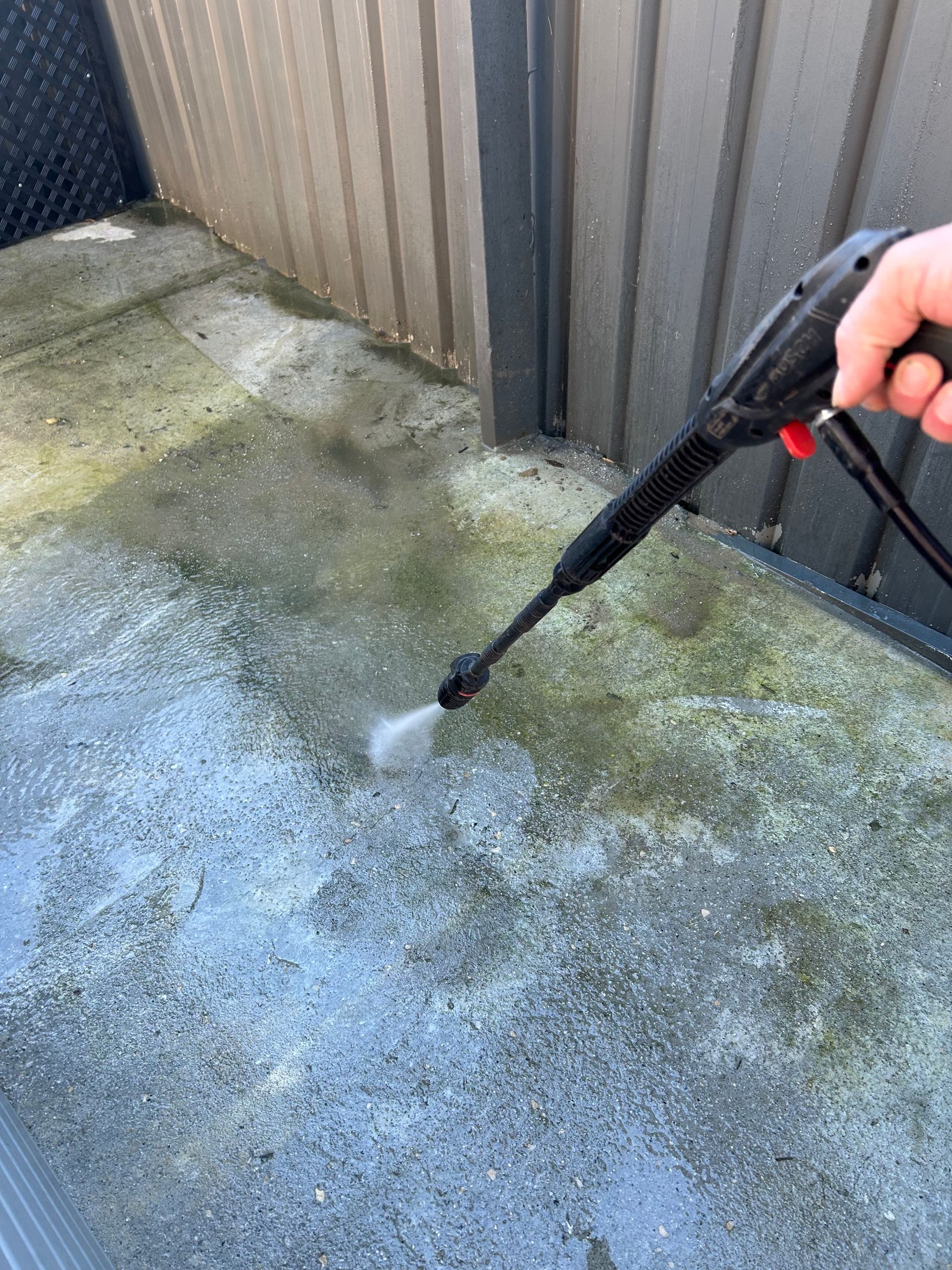Pressure washing removing moss and grime from concrete driveway - A Plus Project Maintenance Wodonga