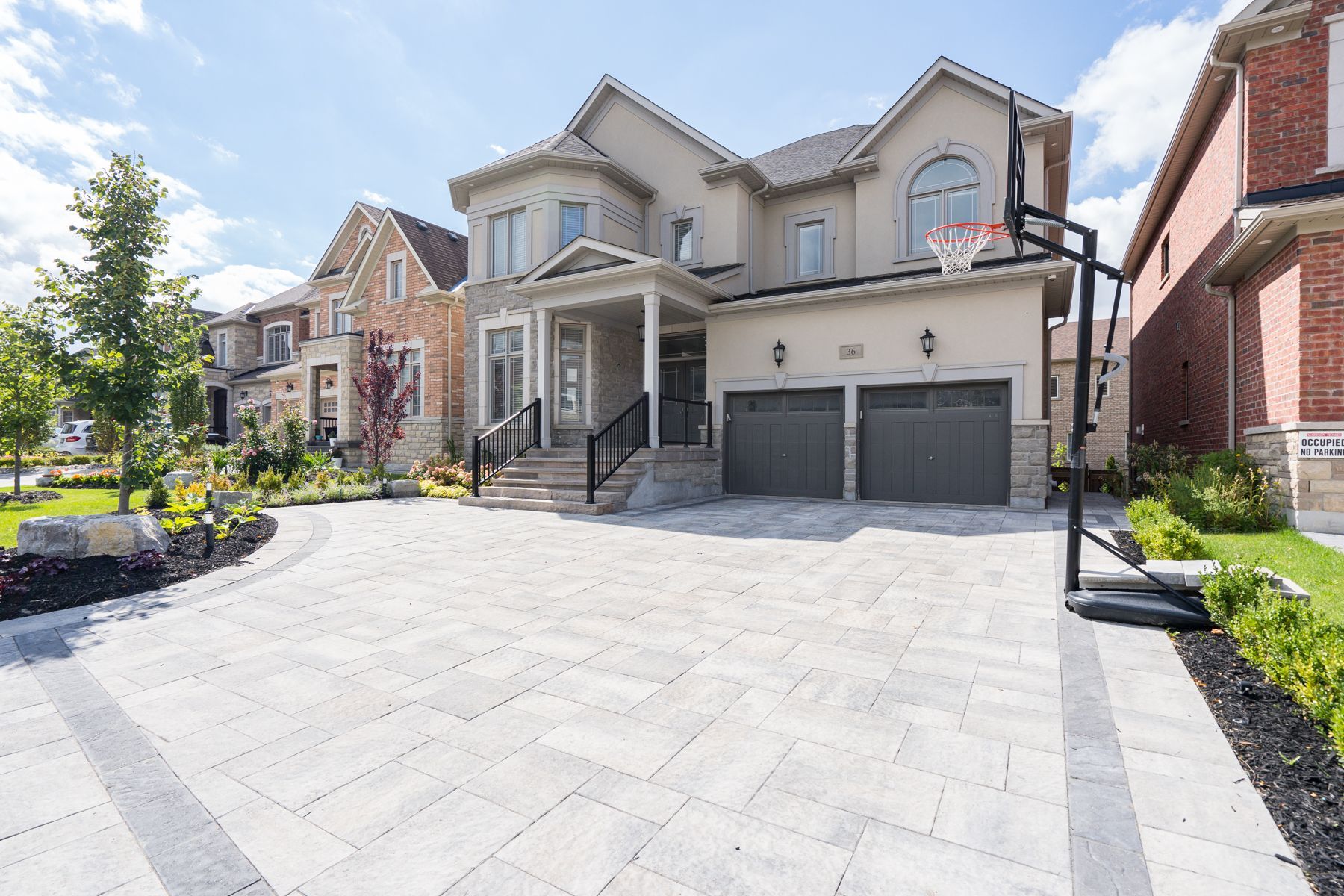 A large house with a basketball hoop in front of it.