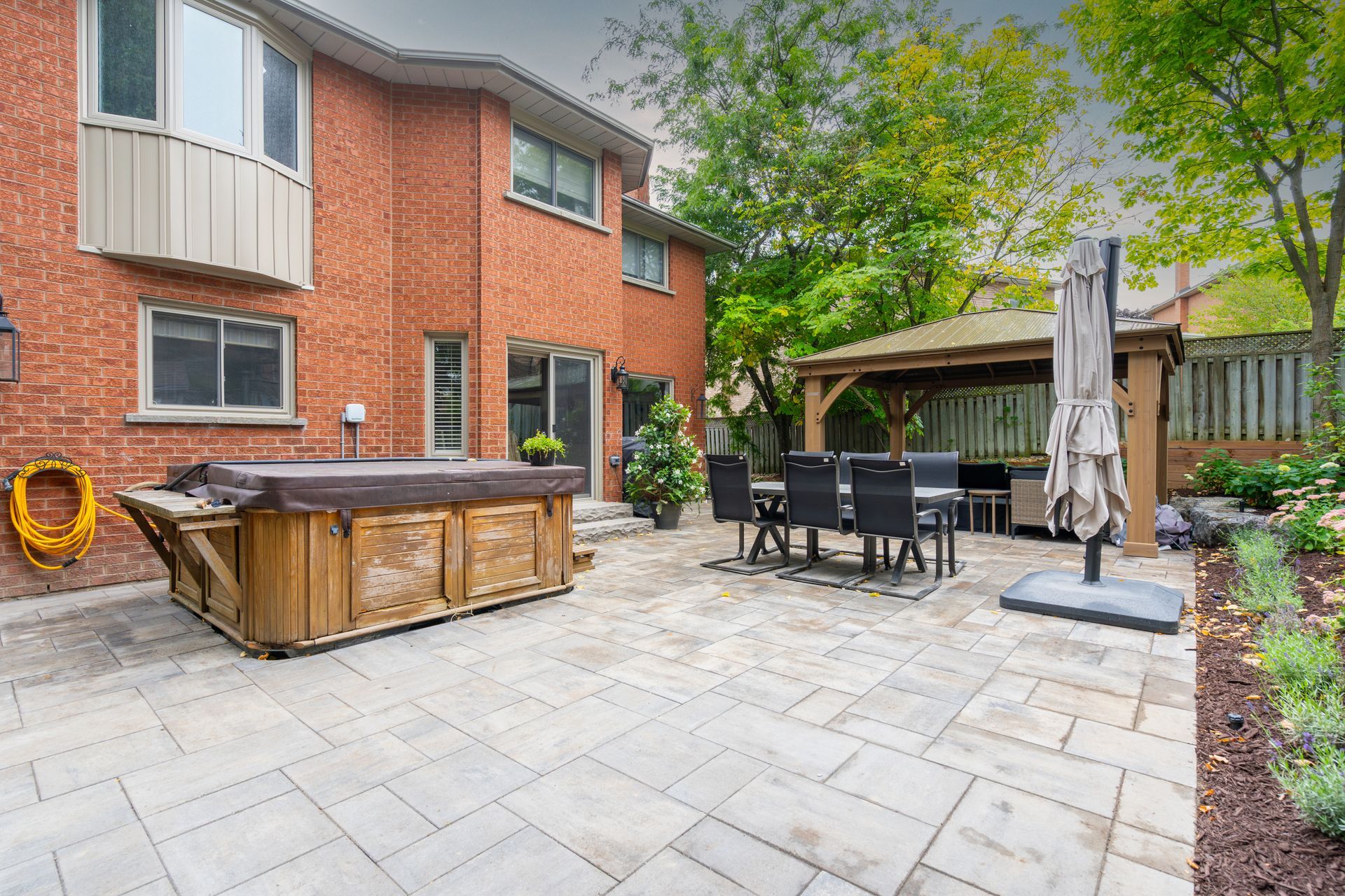 There is a hot tub in the backyard of a house.