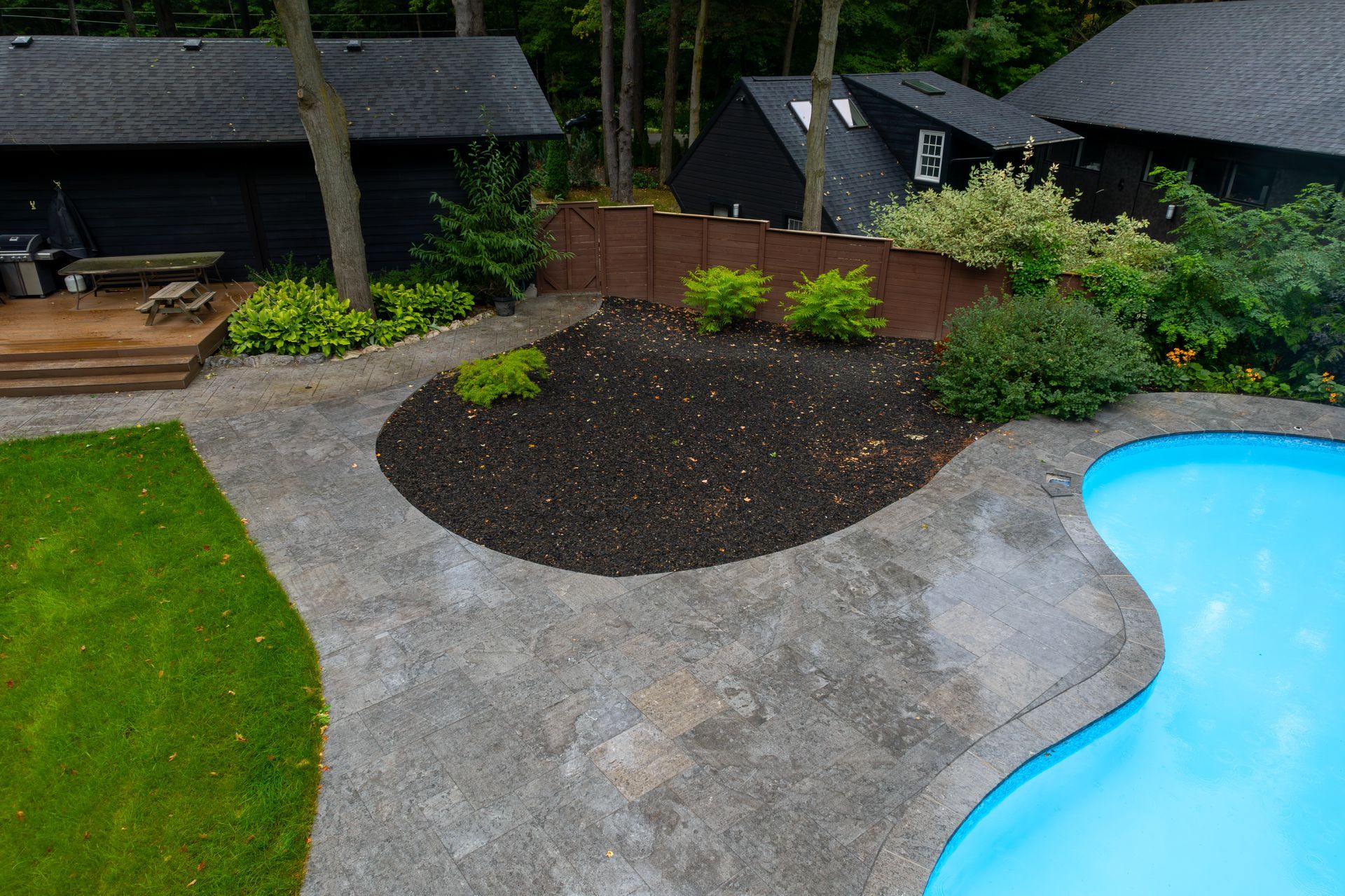 An aerial view of a backyard with a swimming pool