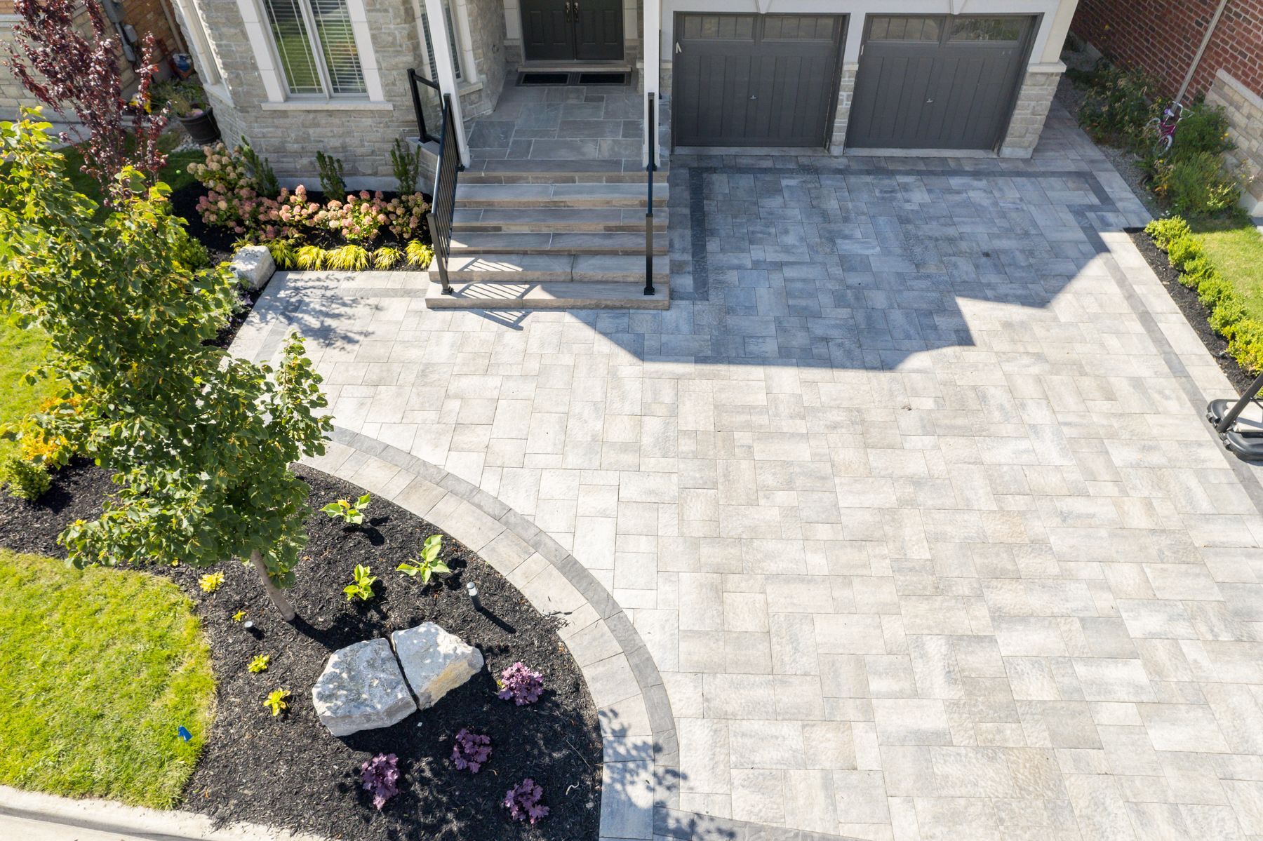 An aerial view of a driveway in front of a house.