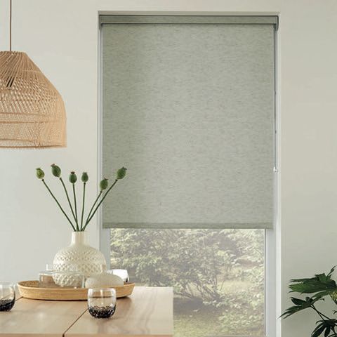 A room with a table and a window with a blind on it.