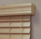 A close up of a wooden blind on a window.