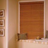 A bathroom with a window with wooden blinds and a bathtub.