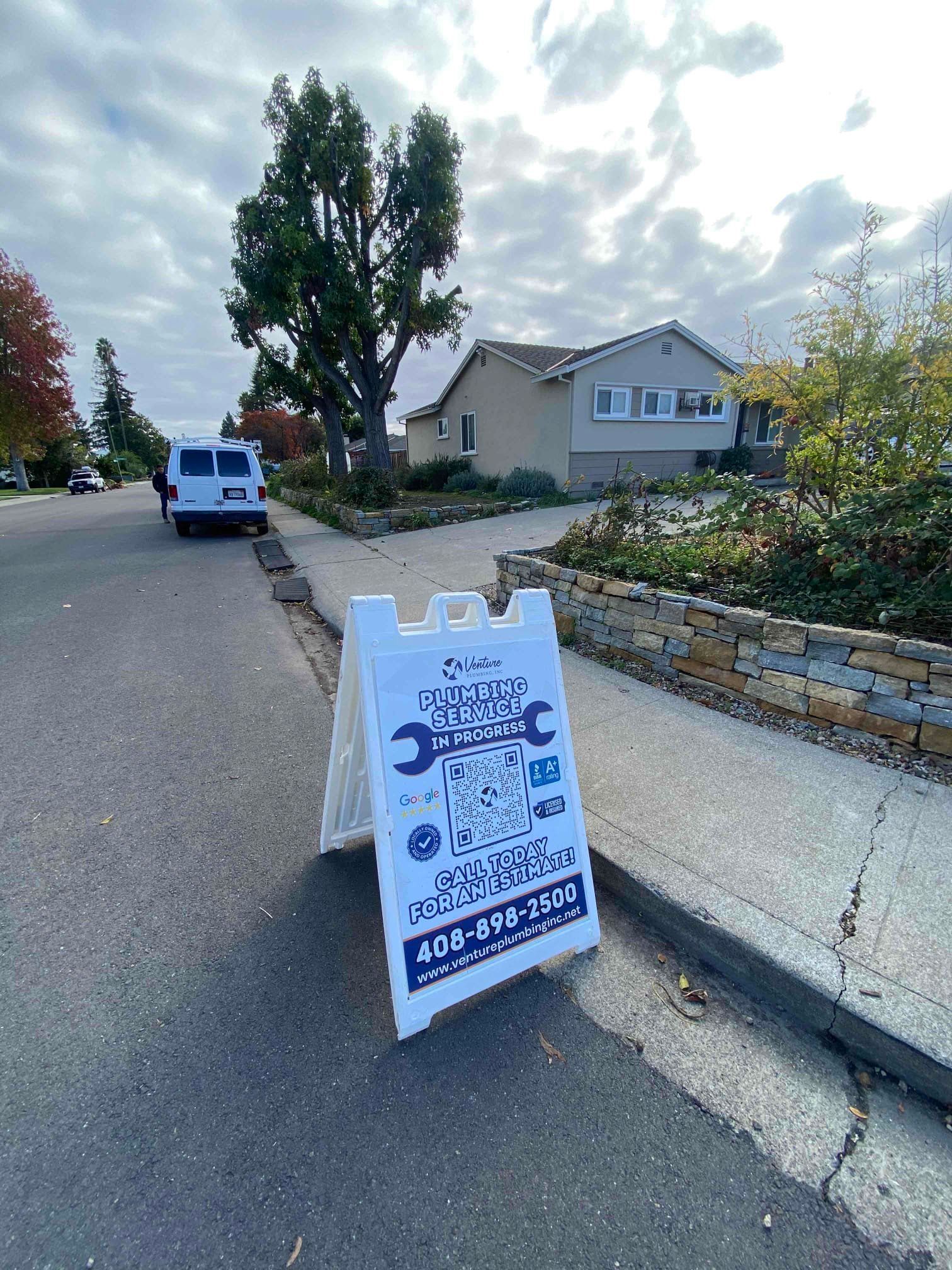 White A-frame sign on street advertising 