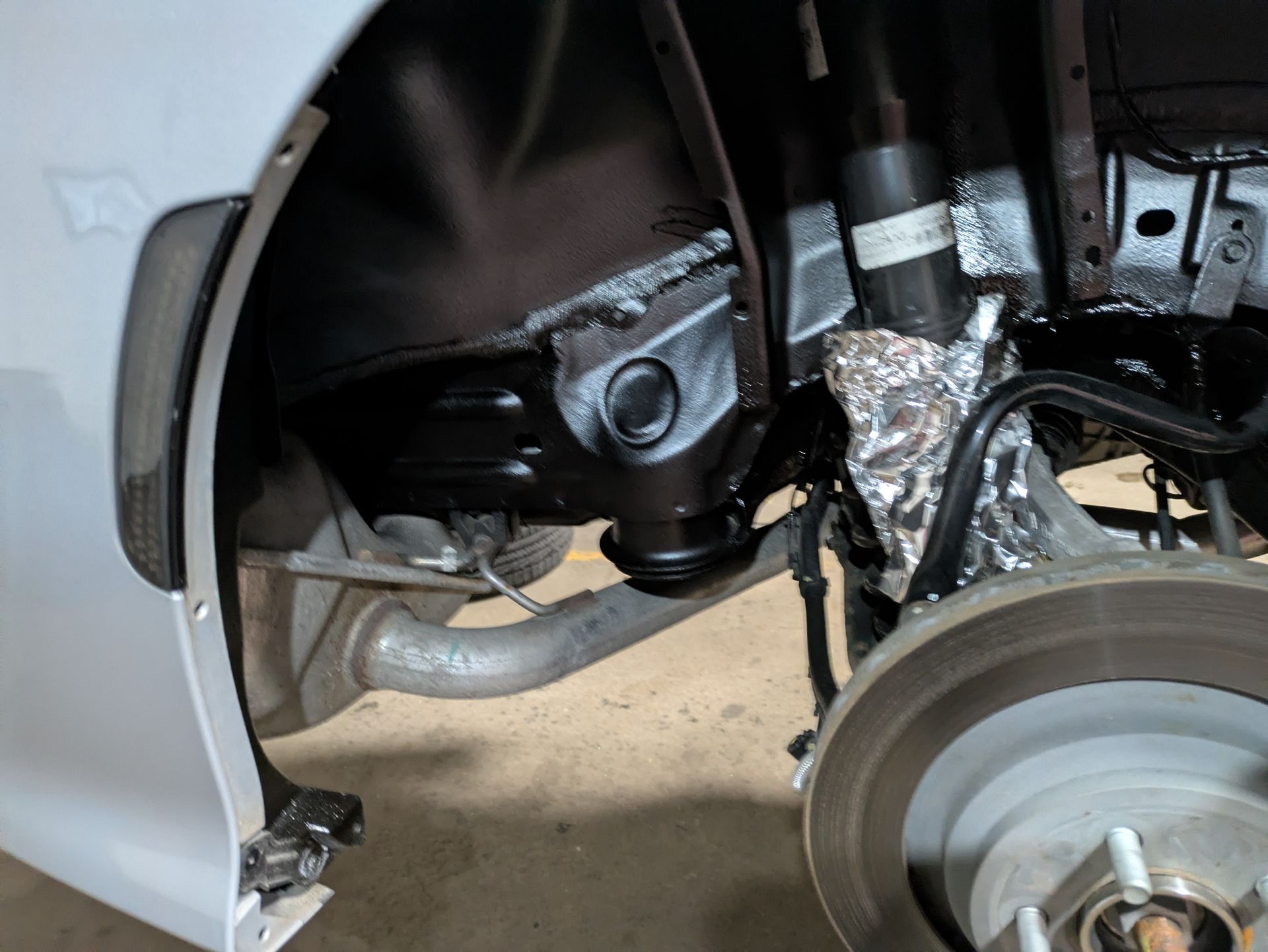 A close up of a car 's suspension and brake system