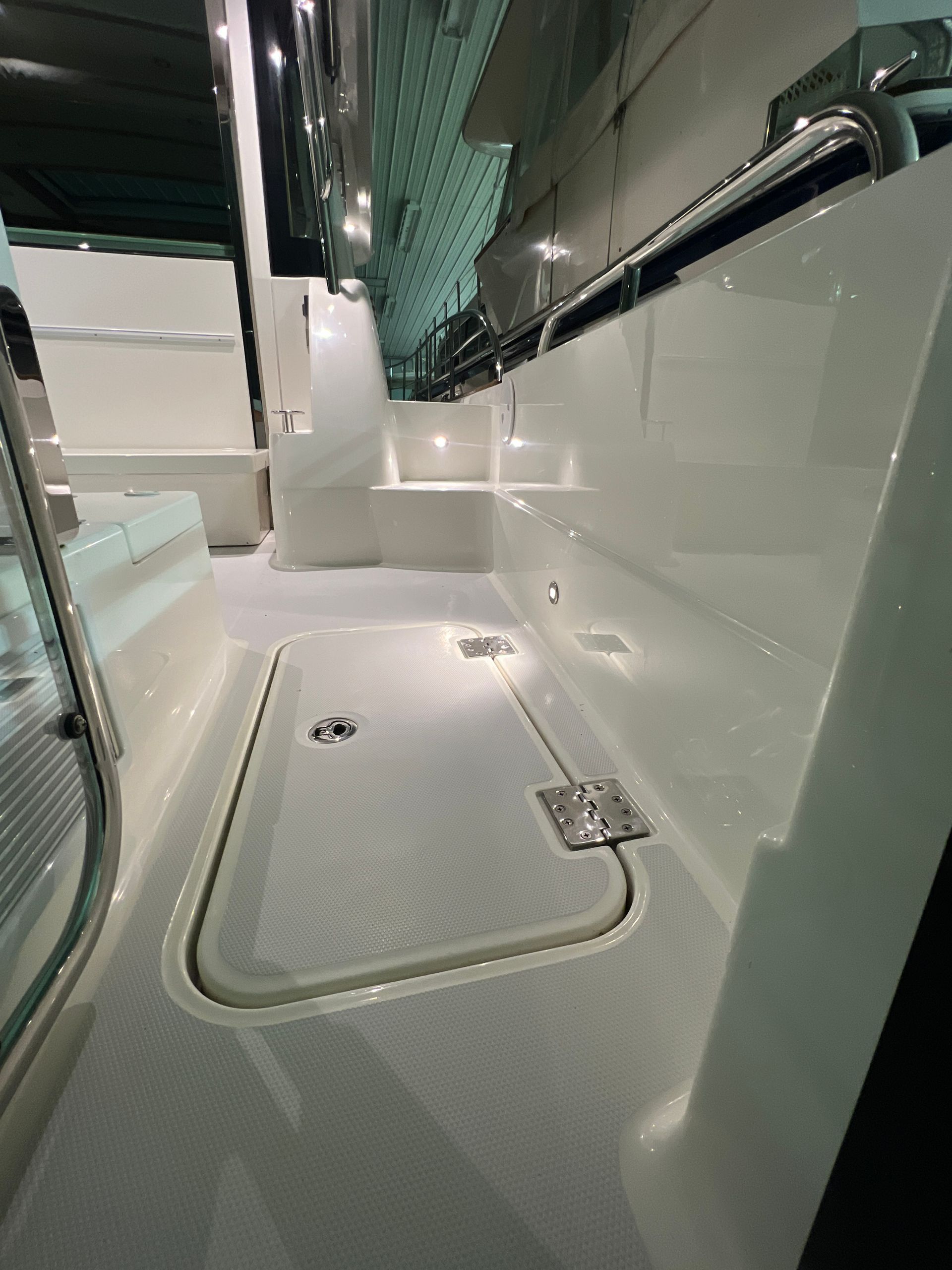 The back of a white boat with a sliding door.
