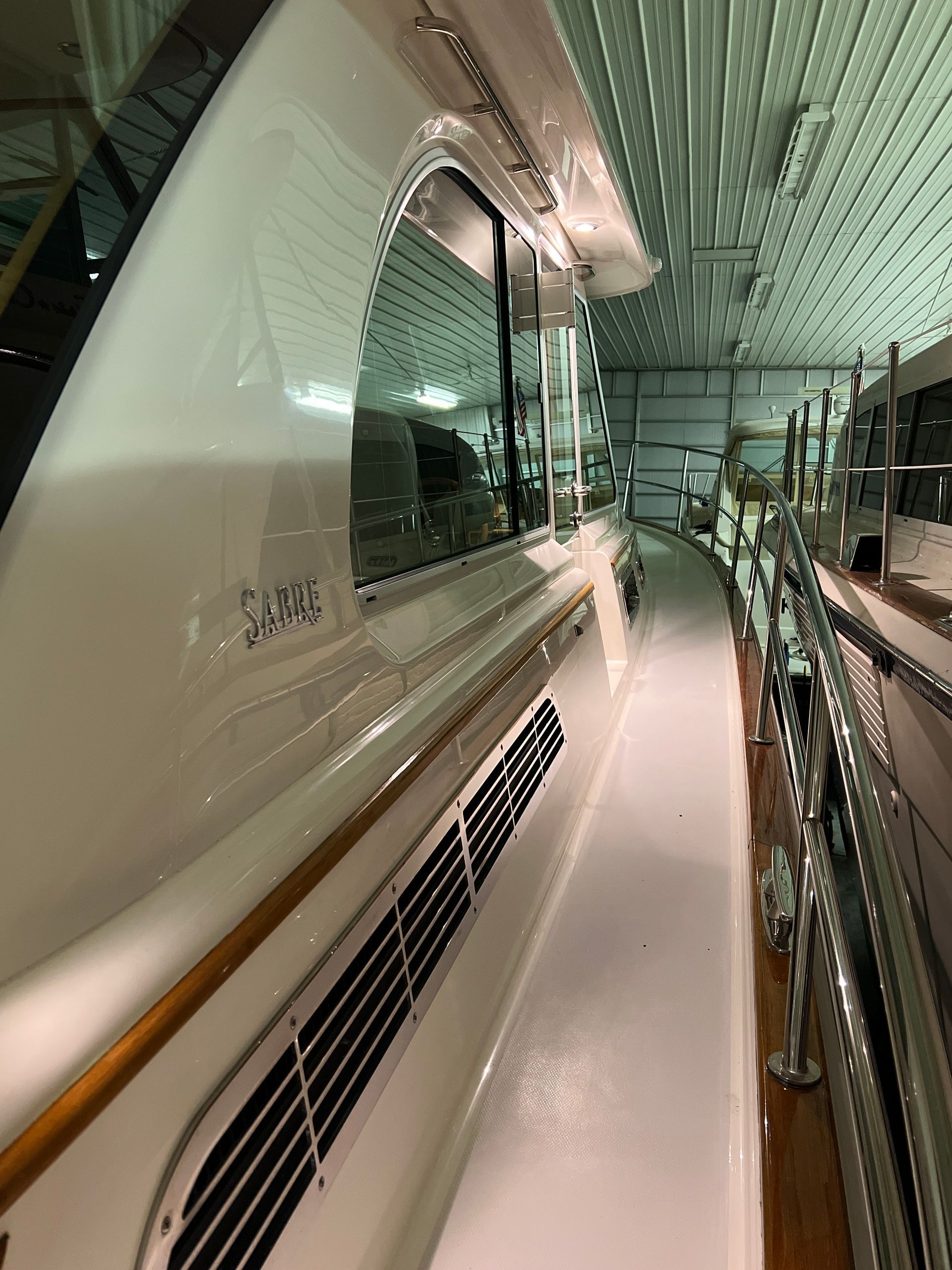 A row of boats are lined up in a garage.