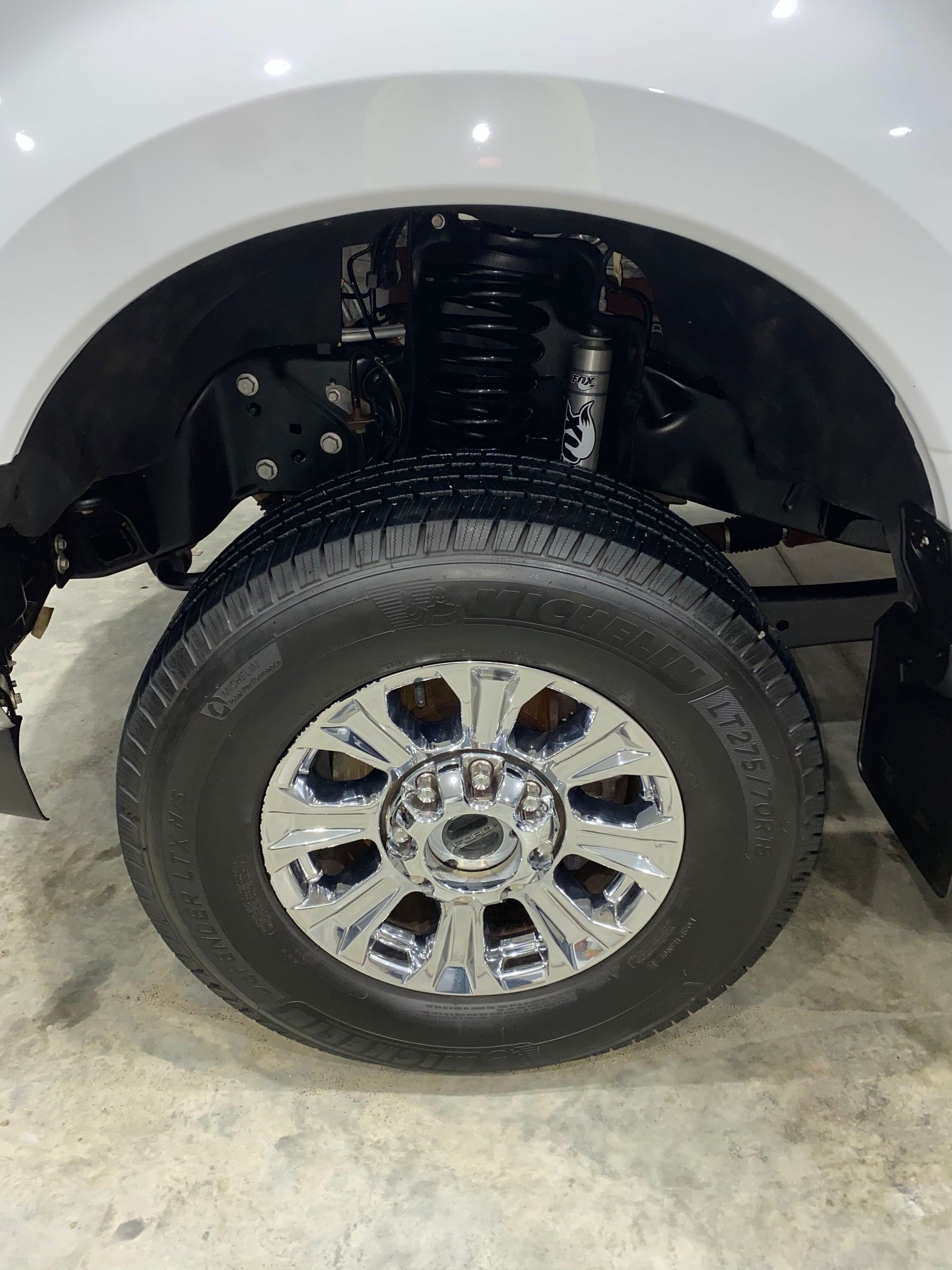 A close up of a tire on a white truck.