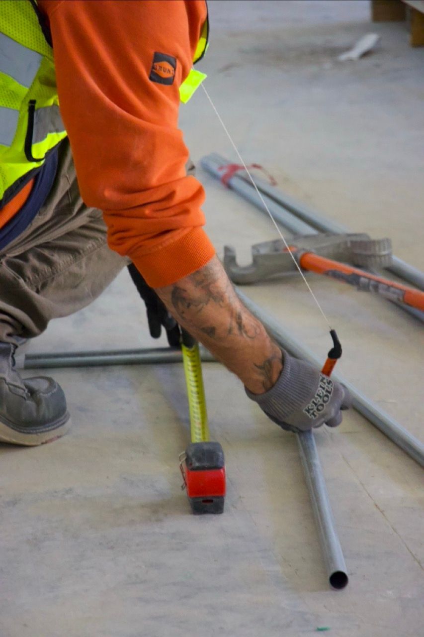 vine electric employee marking conduit for electrical job