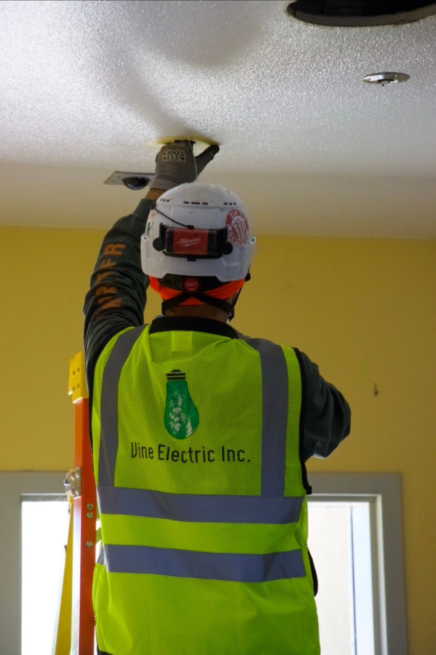 vine electric employee working on the ceiling of a job in rancho