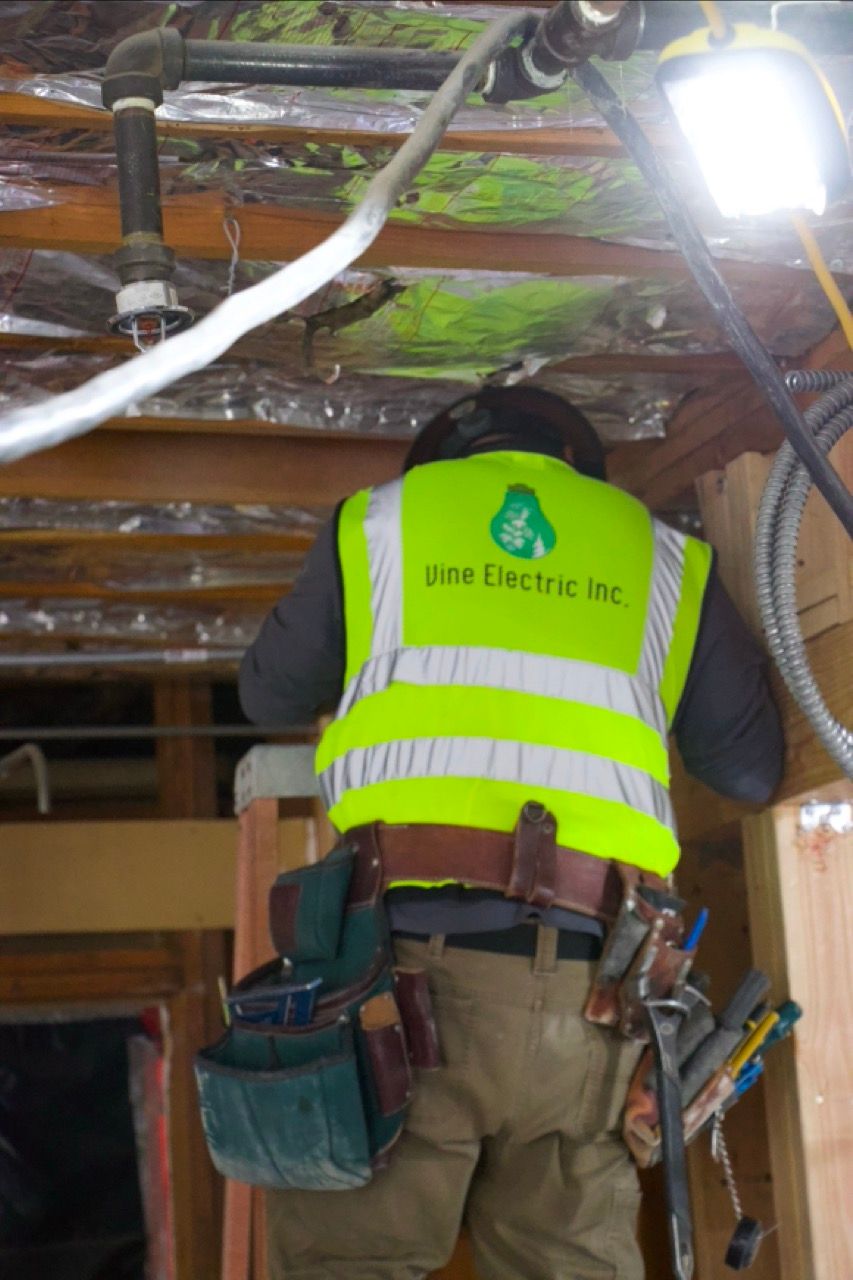 vine electric man working in the rafters for electrical job