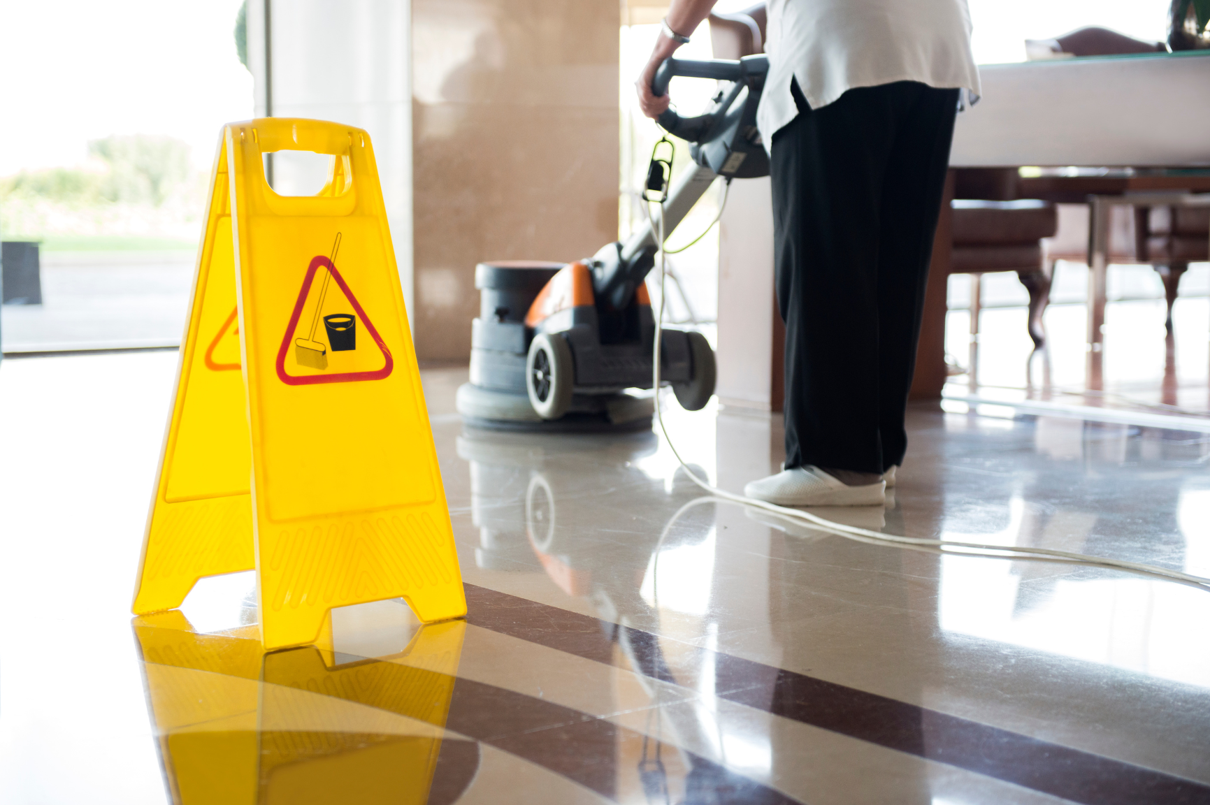 An empty room with a mop and bucket on the floor