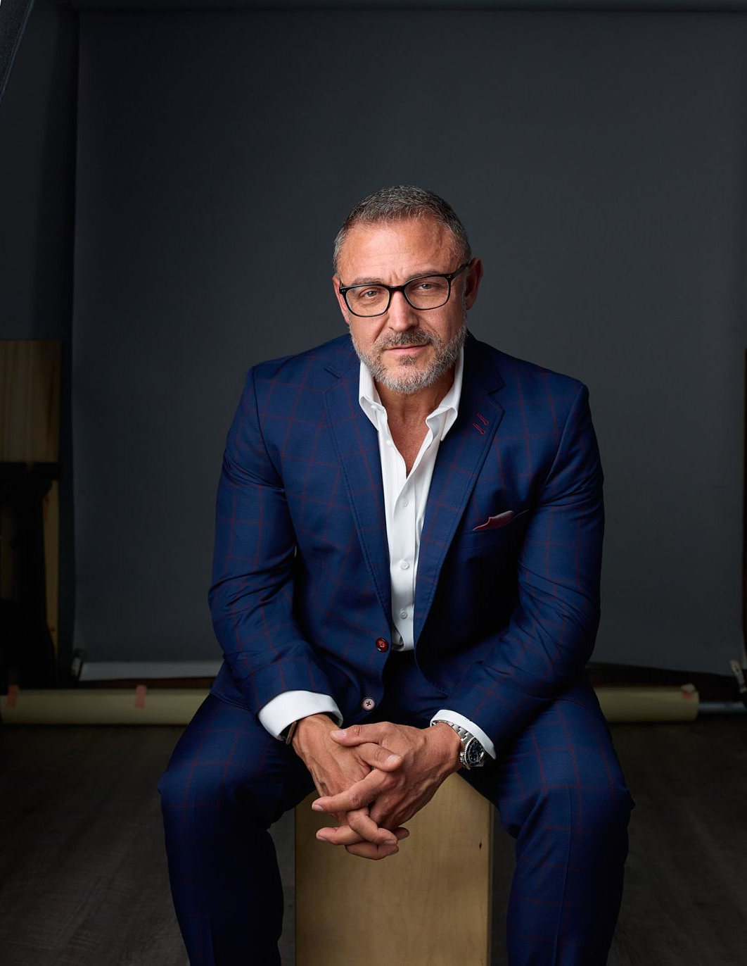 Man in glasses sitting in a studio