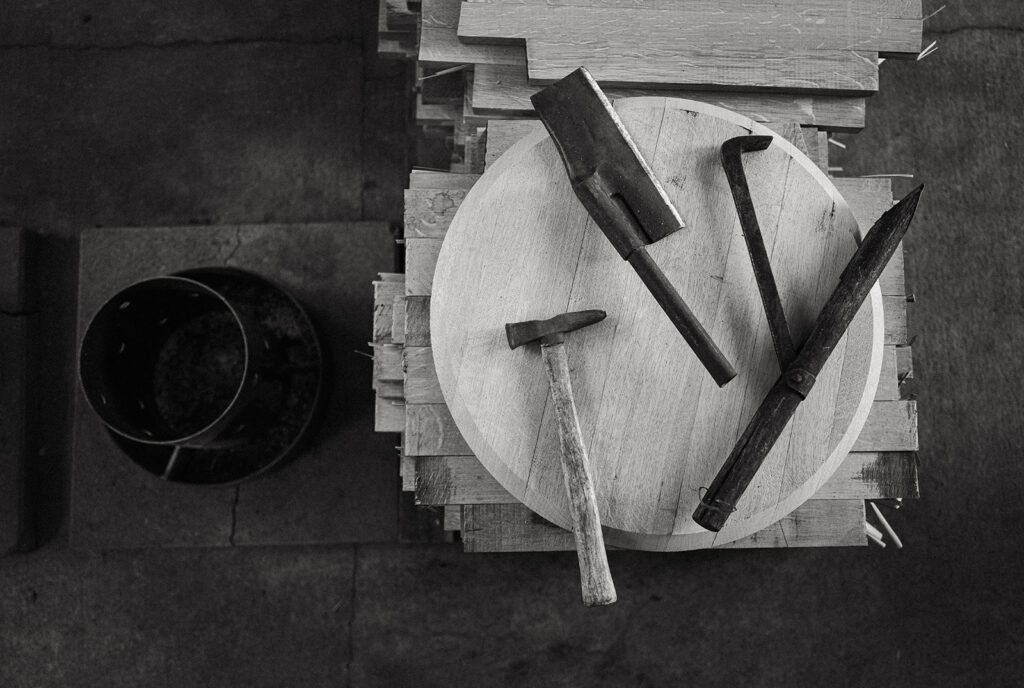 Overhead view of a table with black and white dishes and utensils arranged on a wooden surface