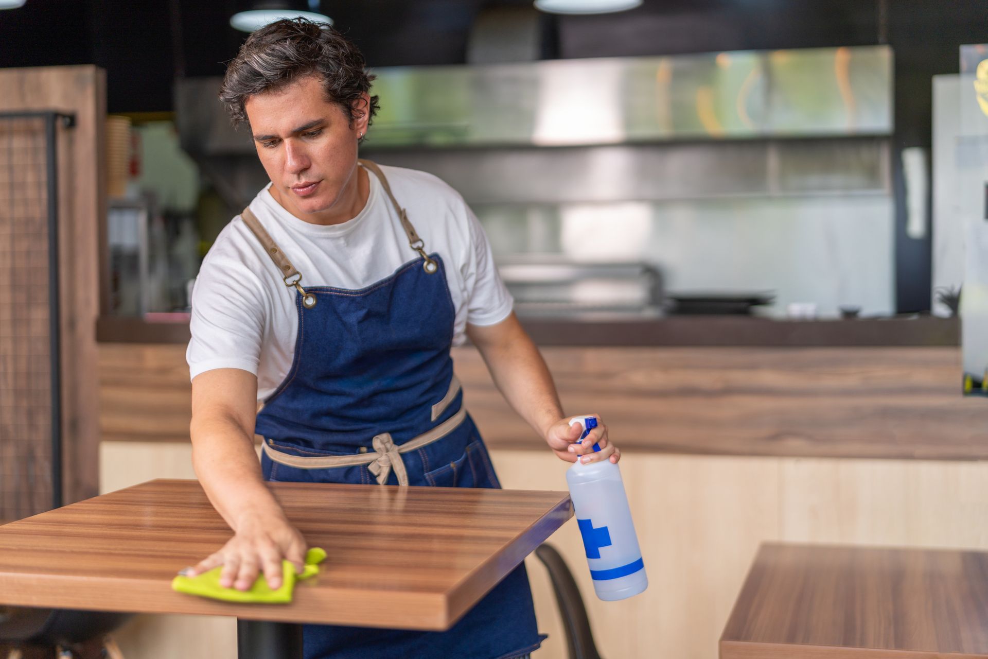 Man Cleaning Table — Central Falls, RI — Fogo Janitorial
