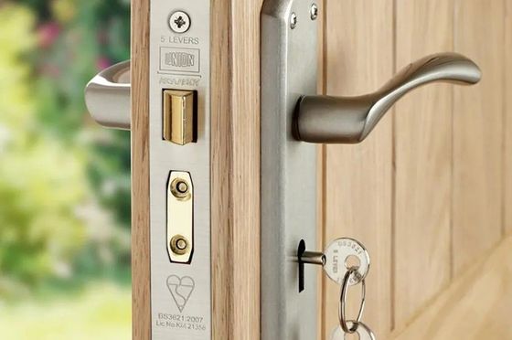 A close up of a house door lock with a key on it. 1st choice Wrexham Locksmiths