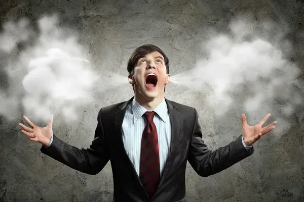 man in suit yelling with steam coming out of ears - anger management