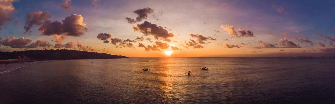 sunset on the bay with fishing boats image