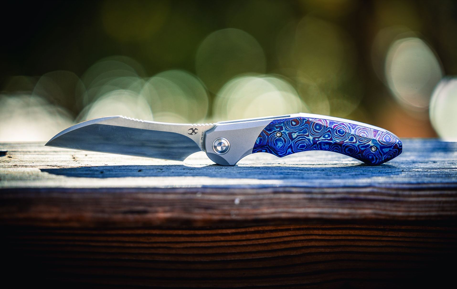 Kizer Comet all versions on denim knife roll