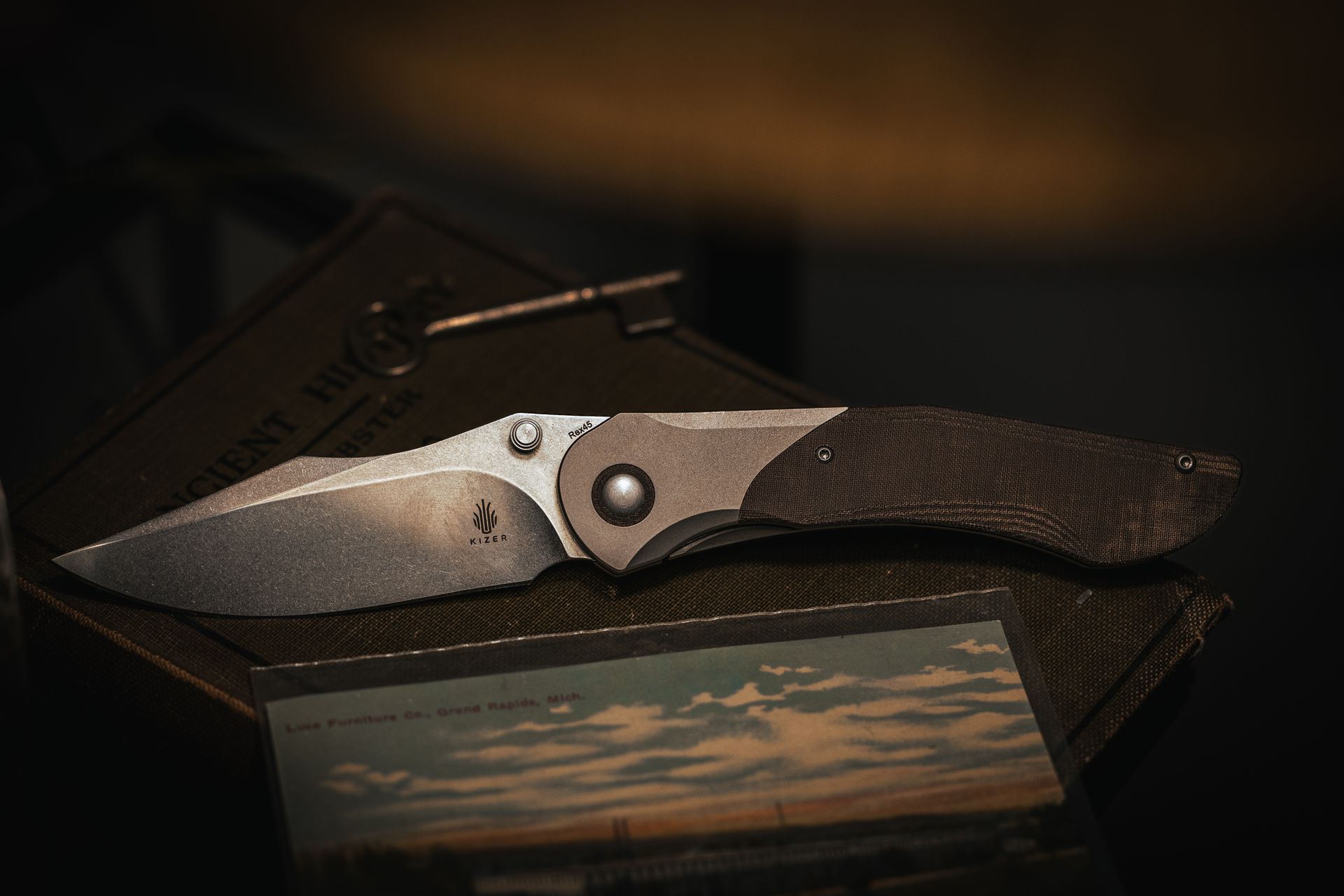 Kizer Comet all versions on denim knife roll