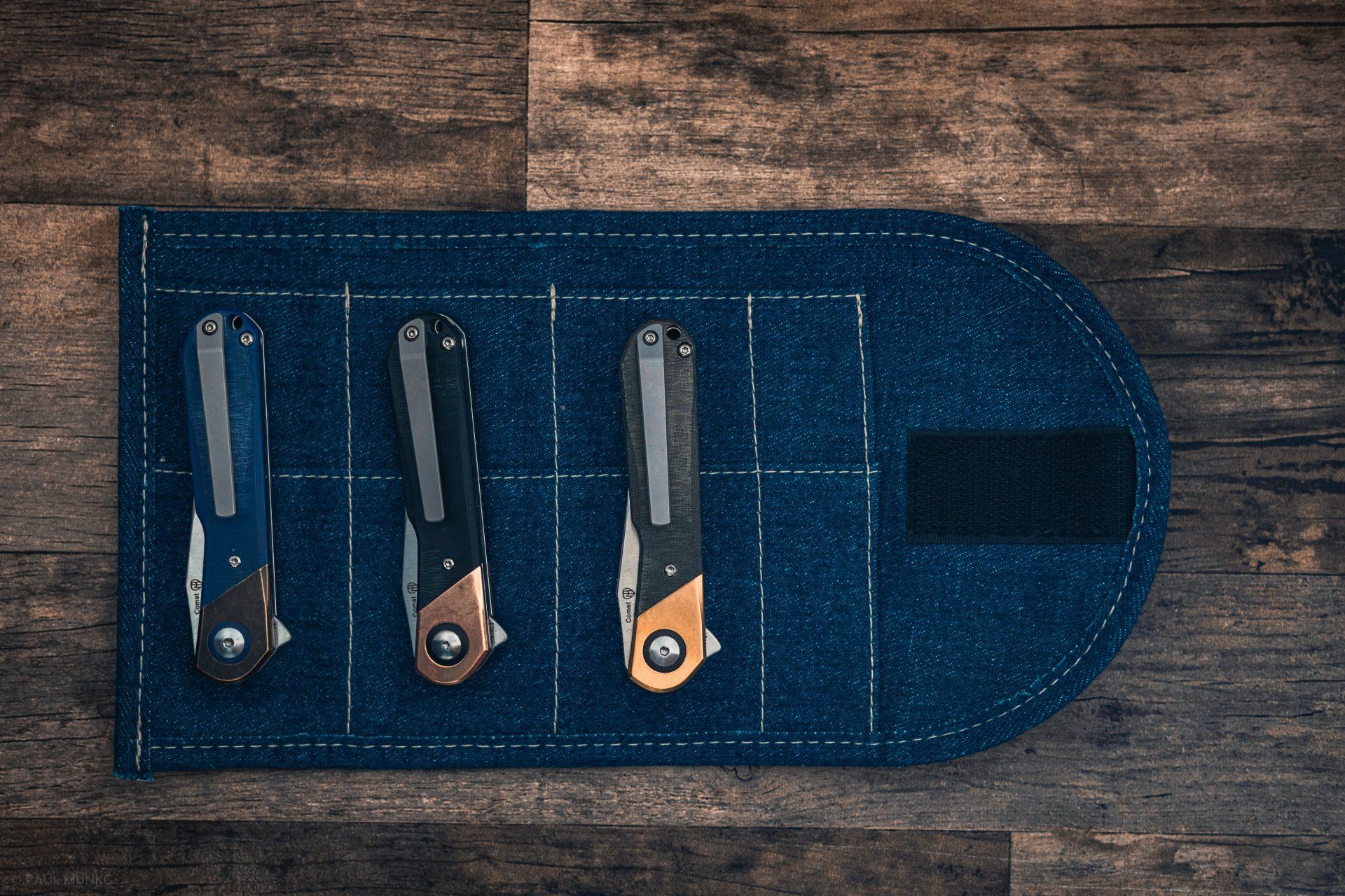 Kizer Comet all versions on denim knife roll