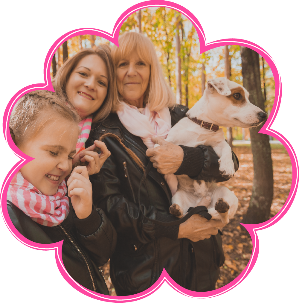 A group of women holding a dog in a pink flower shaped frame