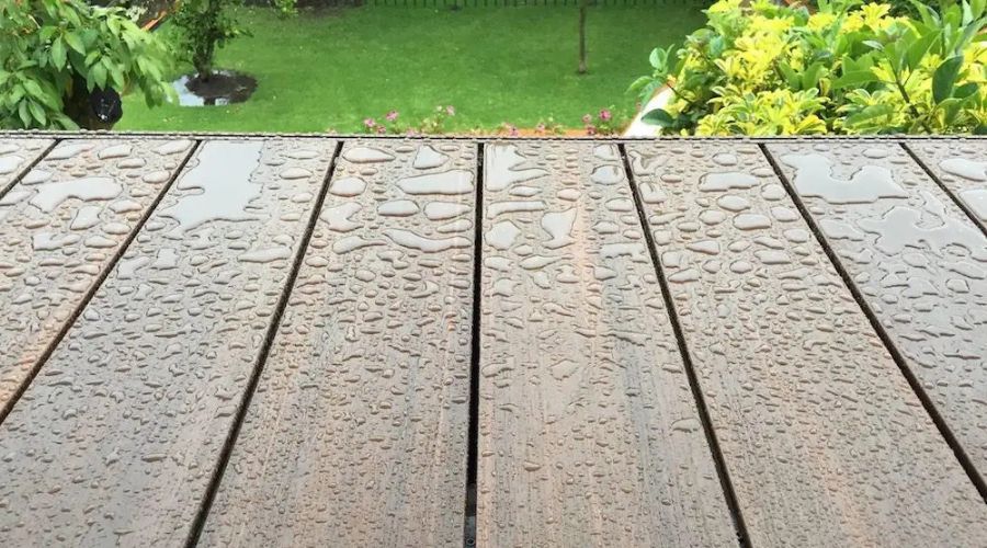 Water-resistant composite decking covered with rain droplets