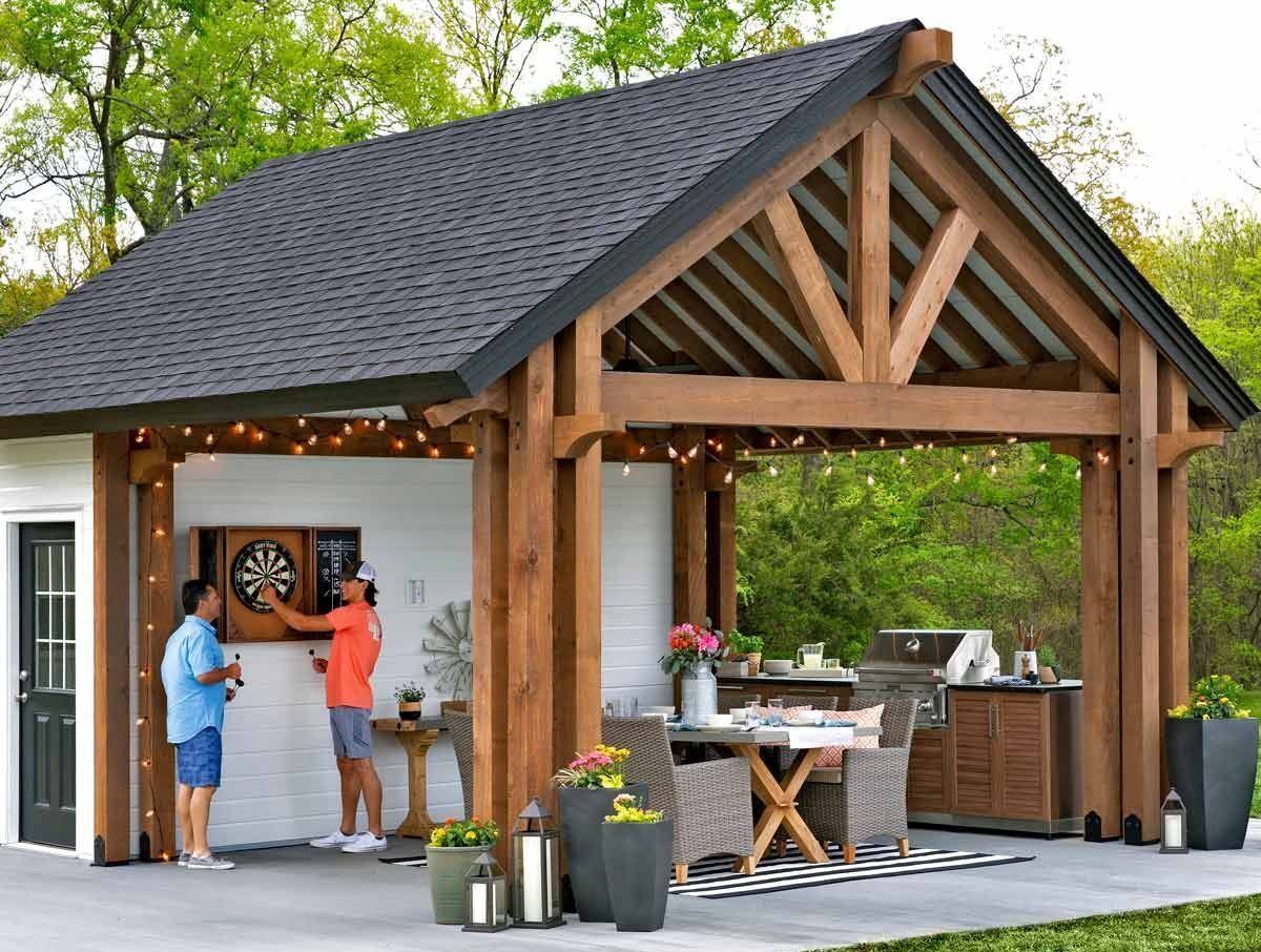 Outdoor wooden patio pavilion with two people serving food at a small bar-style counter