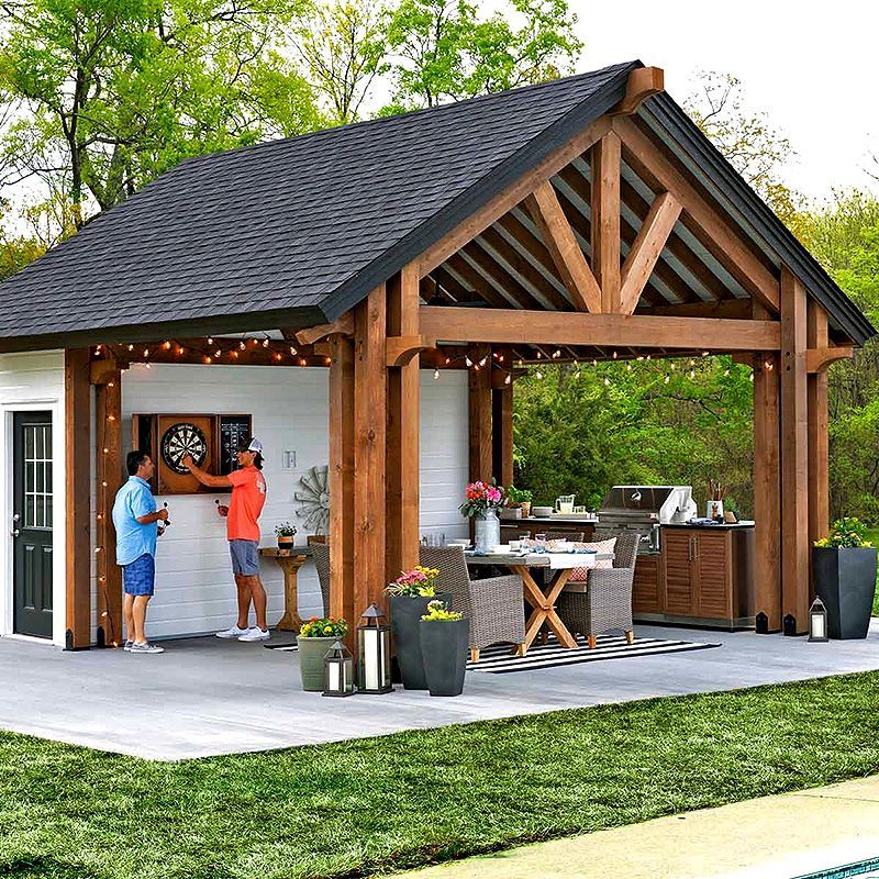 Backyard patio with a wooden pergola, two people talking, grill, and outdoor dining set