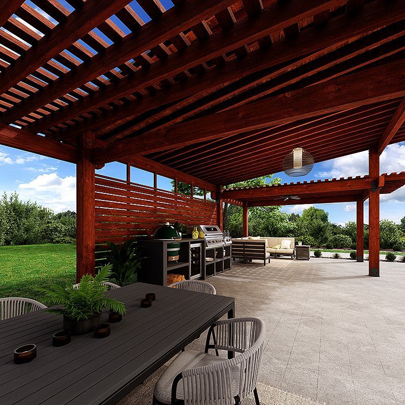 Covered outdoor patio with wooden pergola, dining table, grill, and seating overlooking a green lawn.