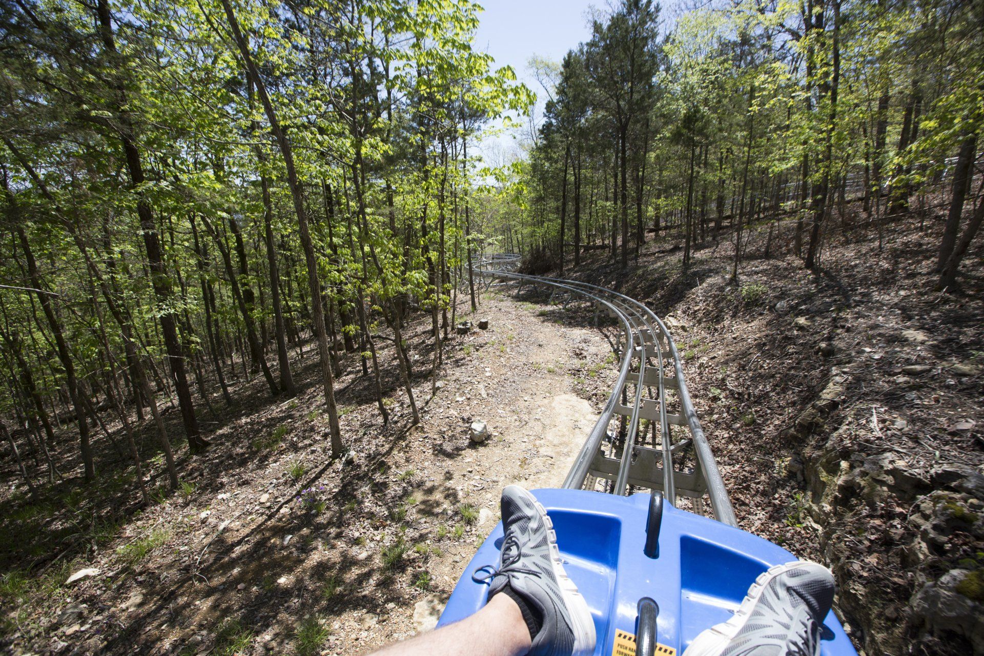 Man and woman riding in the coaster behind the screen