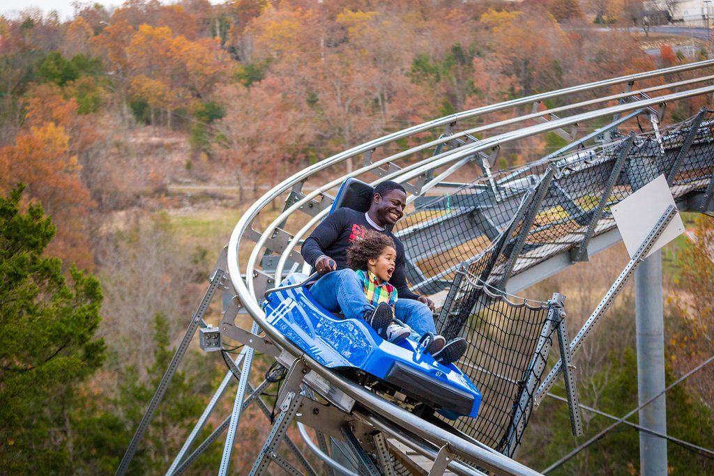 Father and daughter riding in coaster