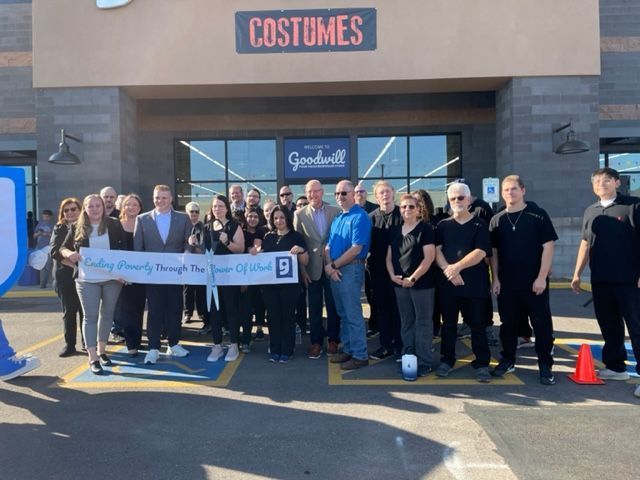 A group of people standing in front of a store called costumes