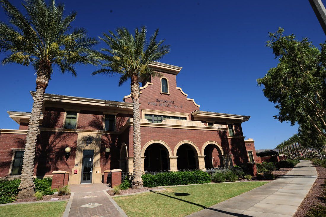 A large brick building with palm trees in front of it