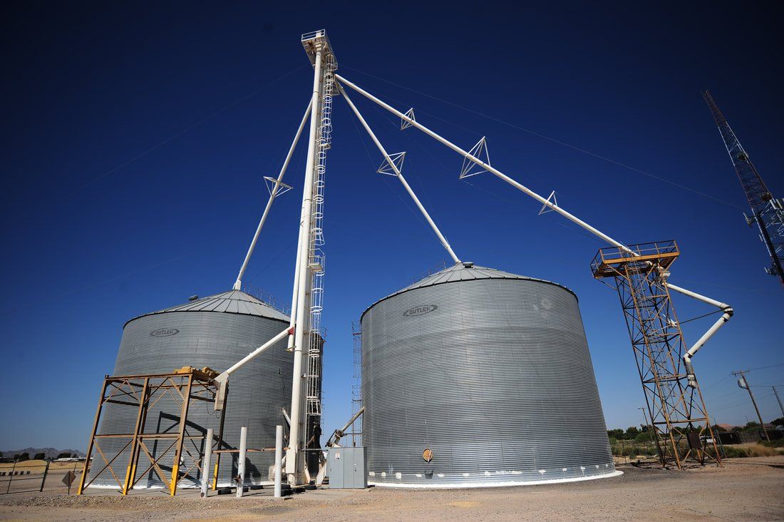 A couple of silos with a blue sky in the background