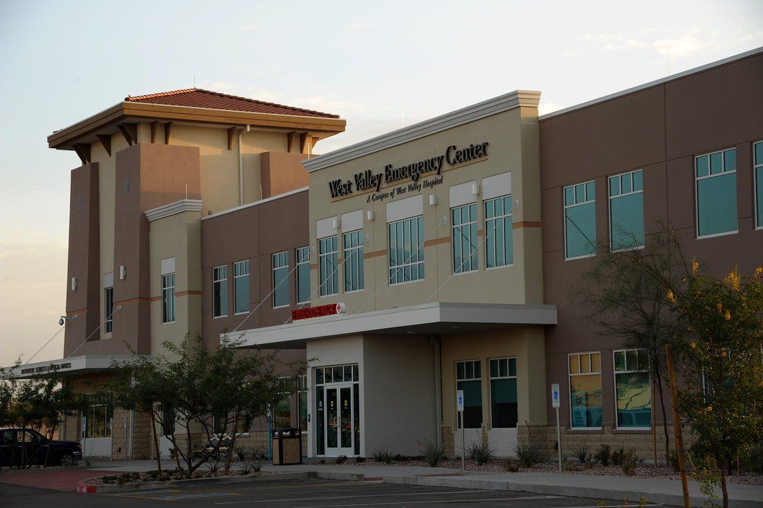 A large building with a lot of windows and trees in front of it.