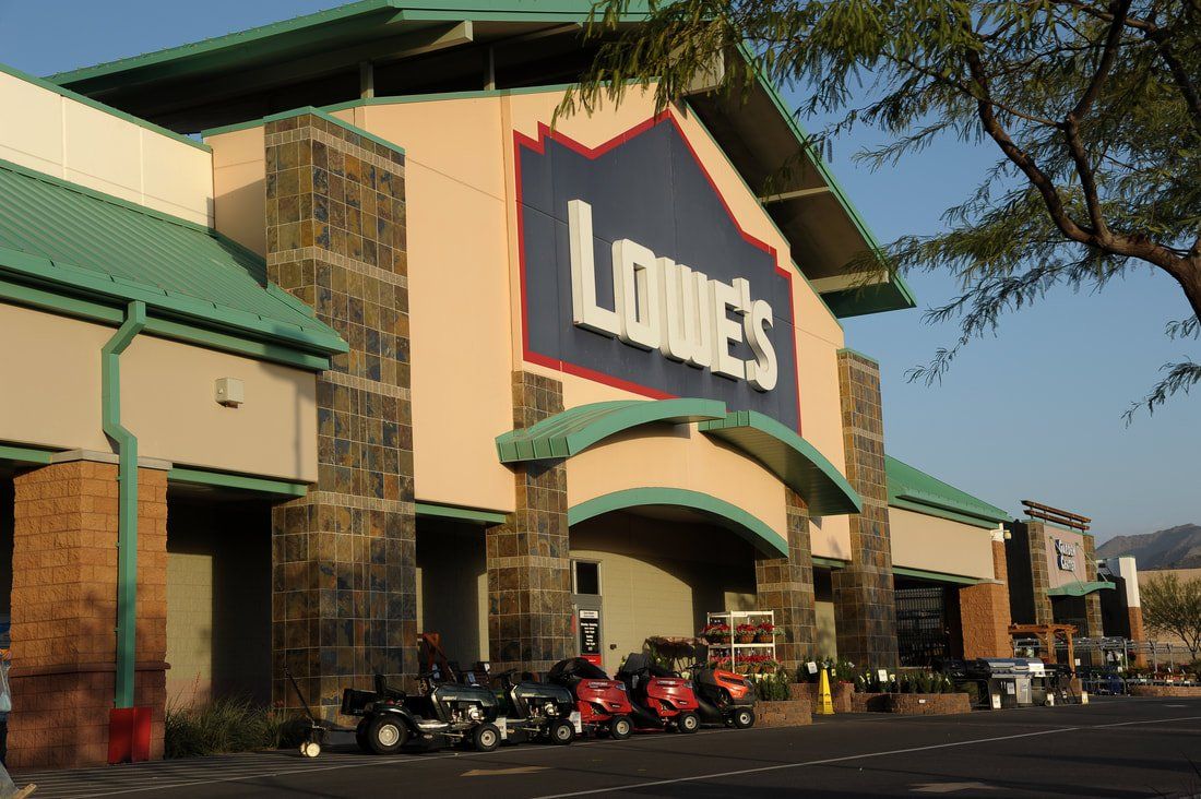 A lowes store with a lot of cars parked in front of it