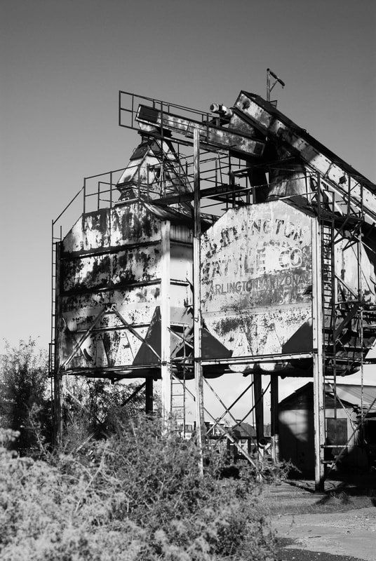 A black and white photo of an abandoned building with a sign that says ' grace ' on it