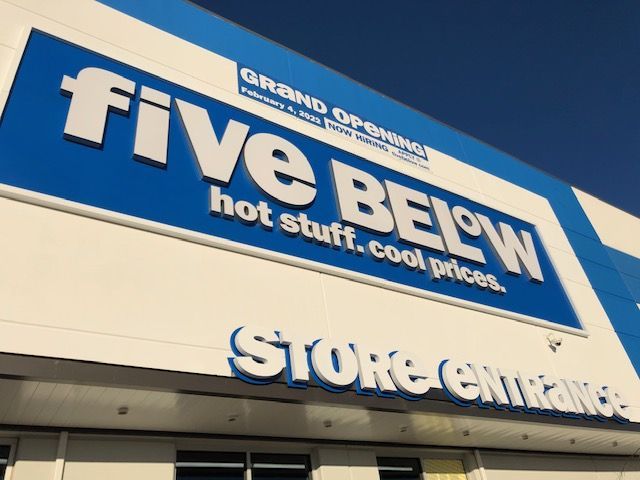 A store front with a sign that says five below hot stuff cool prices