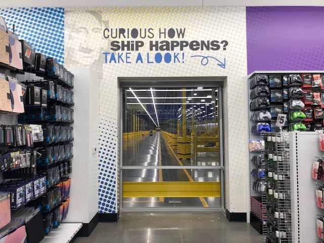 A store with a sign that says curious how ship happens take a look