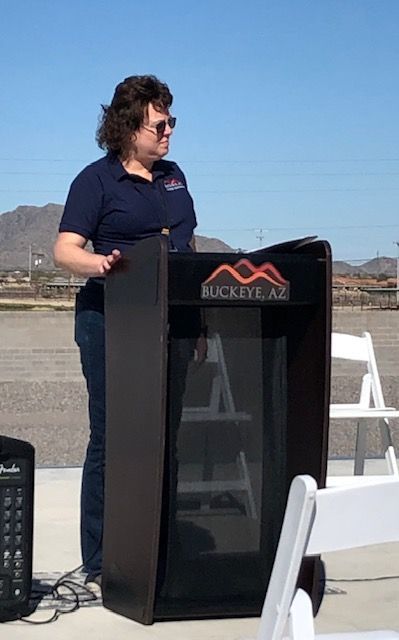 A woman stands at a podium that says buckeye az