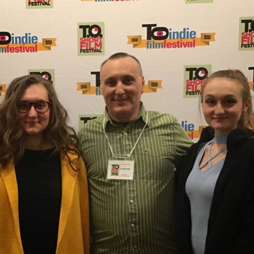 Three people posing at the TO Indie Film Festival step-and-repeat backdrop