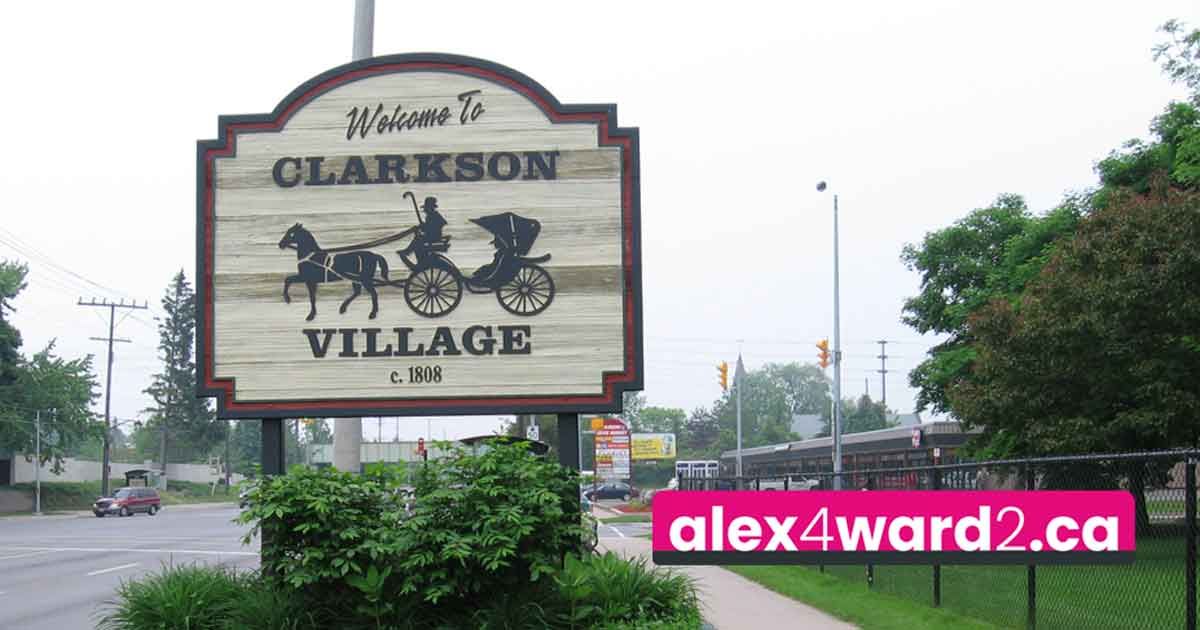 Clarkson Village sign by a sidewalk on a cloudy day