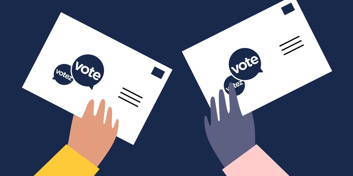 Two hands hold voting ballots with “vote” stickers in blue and white