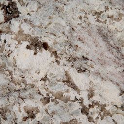 A close up of a white granite counter top with brown spots.