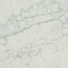 A close up of a white marble counter top.