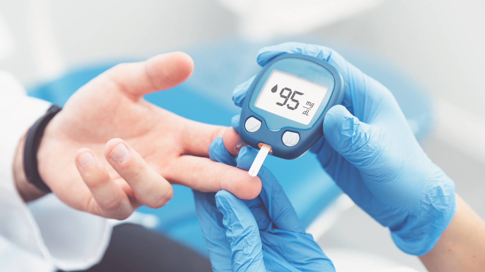 Gloved hands checking a finger with a blood glucose meter showing 95