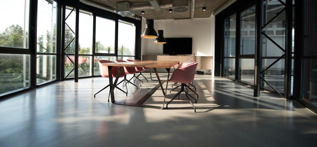 A large conference room with a table and chairs in it.