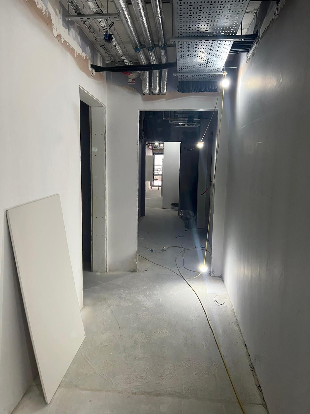 A long hallway in a building under construction.